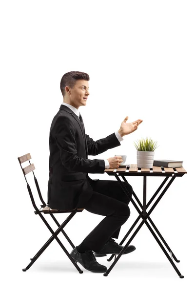 Full Length Profile Shot Young Man Suit Sitting Cafe Gesturing — Stock Photo, Image