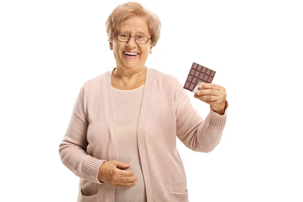 Cheerful Senior Woman Holding Chocolate Bar Smiling Camera Isolated White — Stock Photo, Image