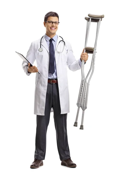 Full Length Portrait Young Male Doctor Holding Pair Crutches Isolated — Stock Photo, Image