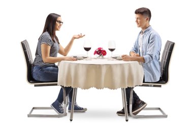Bir restoran masada oturan ve konuşurken beyaz arka plan üzerinde izole kadın ve erkek gençler