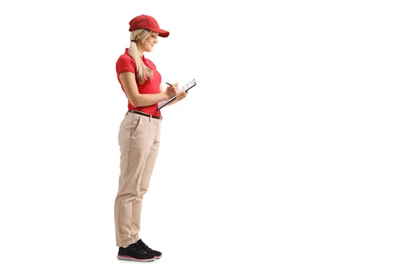 Full Length Shot Female Delivery Worker Uniform Writing Clipboard Isolated — Stock Photo, Image