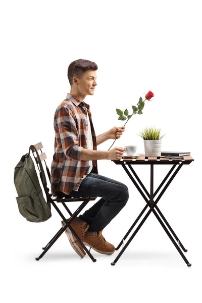 Foto Perfil Completo Estudiante Masculino Sosteniendo Una Rosa Roja Sentado — Foto de Stock