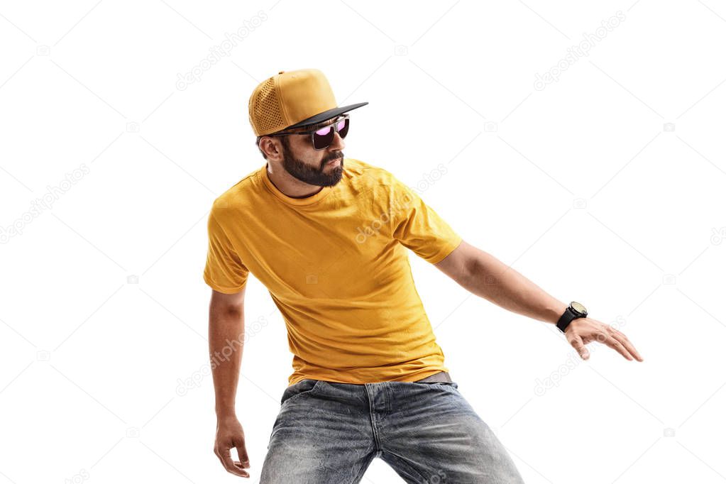 Male hipster in yellow t-shirt performing dancing moves  isolated on white background
