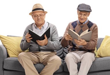 İki yaşlı adam bir kanepede oturan ve okuma kitap beyaz arka planda izole