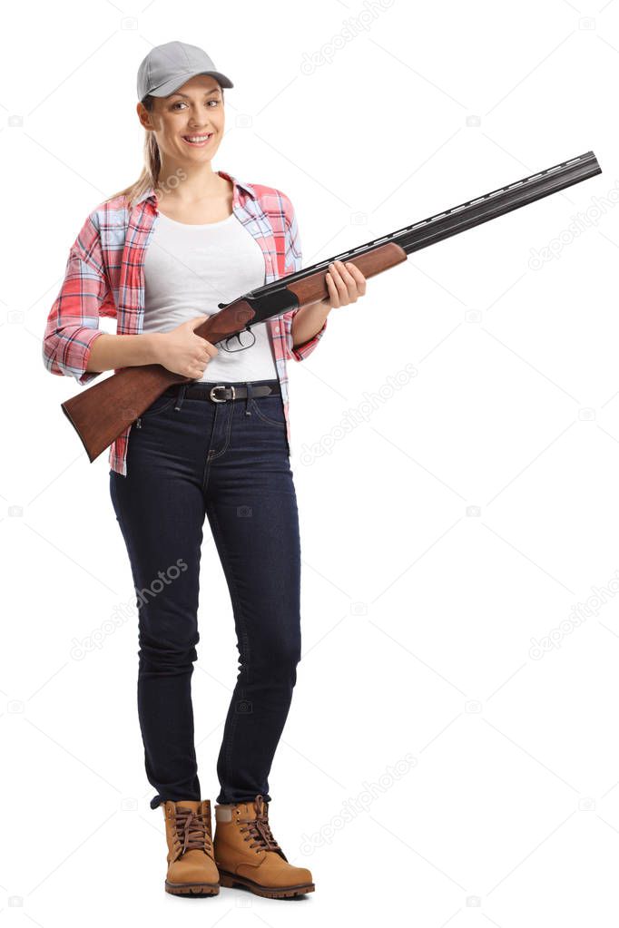 Full length portrait of a young woman with a shotgun isolated on white background