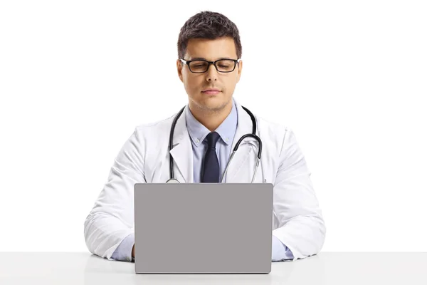 Young Male Doctor Sitting Desk Working Laptop Isolated White Background — Stock Photo, Image