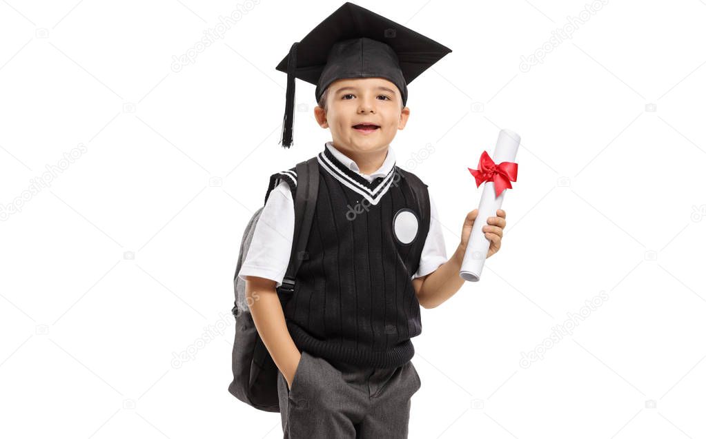 Schoolboy in a uniform with a graduation hat and a diploma isolated on white background