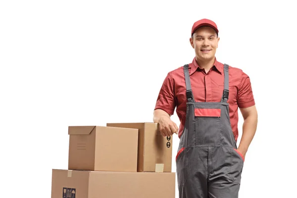 Delivery Man Leaning Stack Boxes Loaded Hand Truck Isolated White — Stock Photo, Image