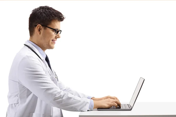 Profile Shot Young Male Doctor Sitting Working Laptop Isolated White — Stock Photo, Image