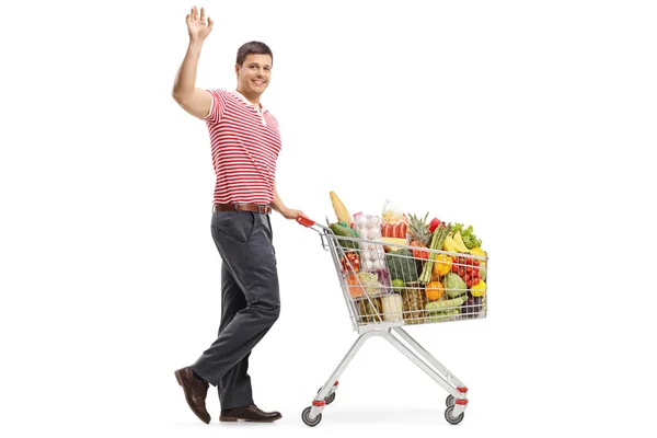 Full Length Shot Young Man Shopping Cart Smiling Waving Isolated — Stock Photo, Image