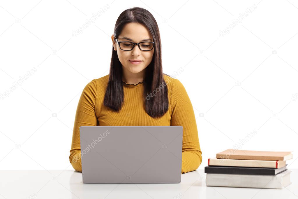 Young woman working on a laptop isolated on white background