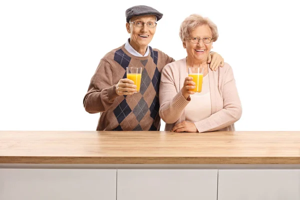 Smiling Elderly Man Woman Holding Glasses Orange Juice Wooden Counter — Stock Photo, Image