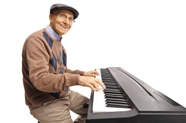 Cheerful senior man playing a digital keyboard piano isolated on white background clipart