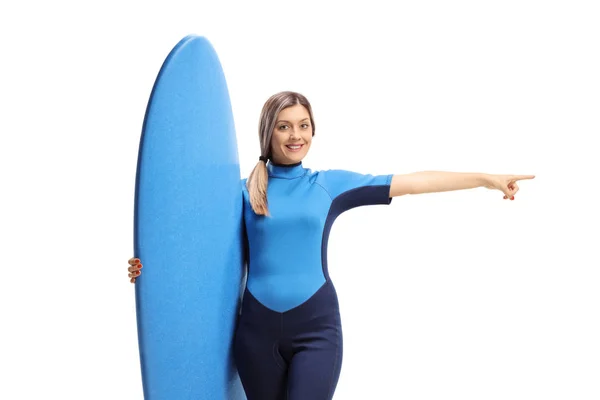 Vrouw Een Wetsuit Met Een Surfplank Wijzend Naar Een Kant — Stockfoto