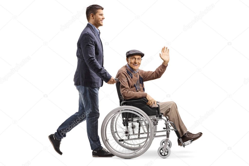 Son pushing his father waving from a wheelchair