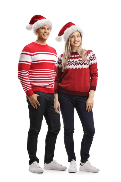 Młody mężczyzna i kobieta ubrany w Boże Narodzenie Santa kapelusz i swetry — Zdjęcie stockowe