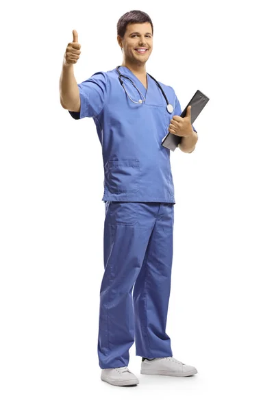 Full Length Portrait Young Male Doctor Holding Clipboard Showing Thumbs — Stock Photo, Image