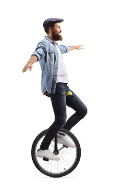 Young man on a unicycle balancing with hands