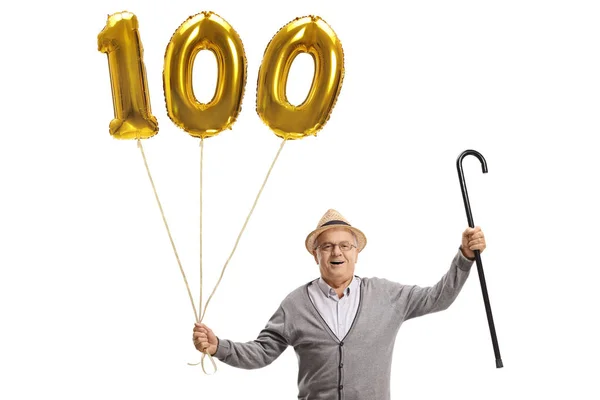 Glücklicher Senior mit goldenem Luftballon — Stockfoto