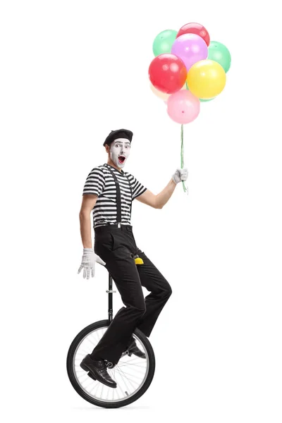 Pantomime man on a unicycle holding a bunch of colorful balloons — Stock Photo, Image