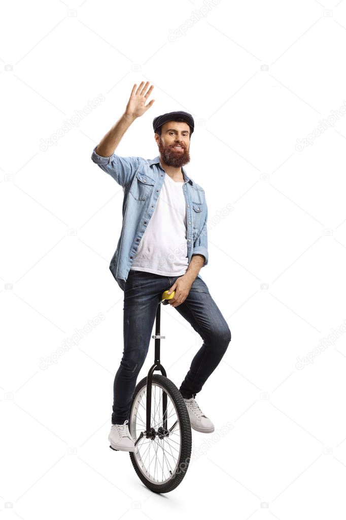 Man riding a unicycle and waving at the camera