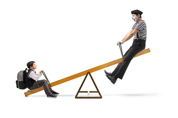 Schoolboy and a mime on a seesaw — Stock Photo, Image