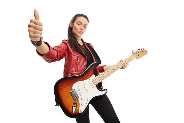 Young woman with an electric guitar showing thumbs up — Stock Photo, Image
