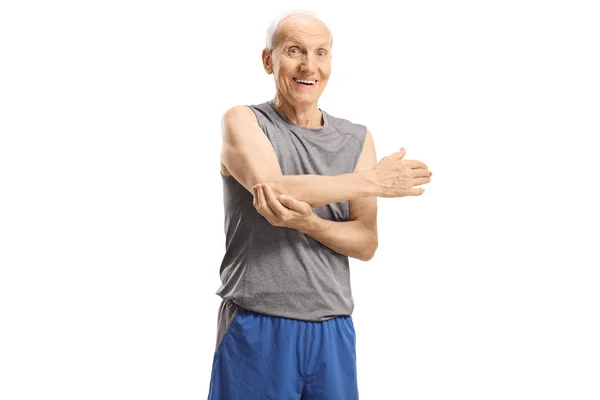 Anciano en ropa deportiva estirando su brazo —  Fotos de Stock