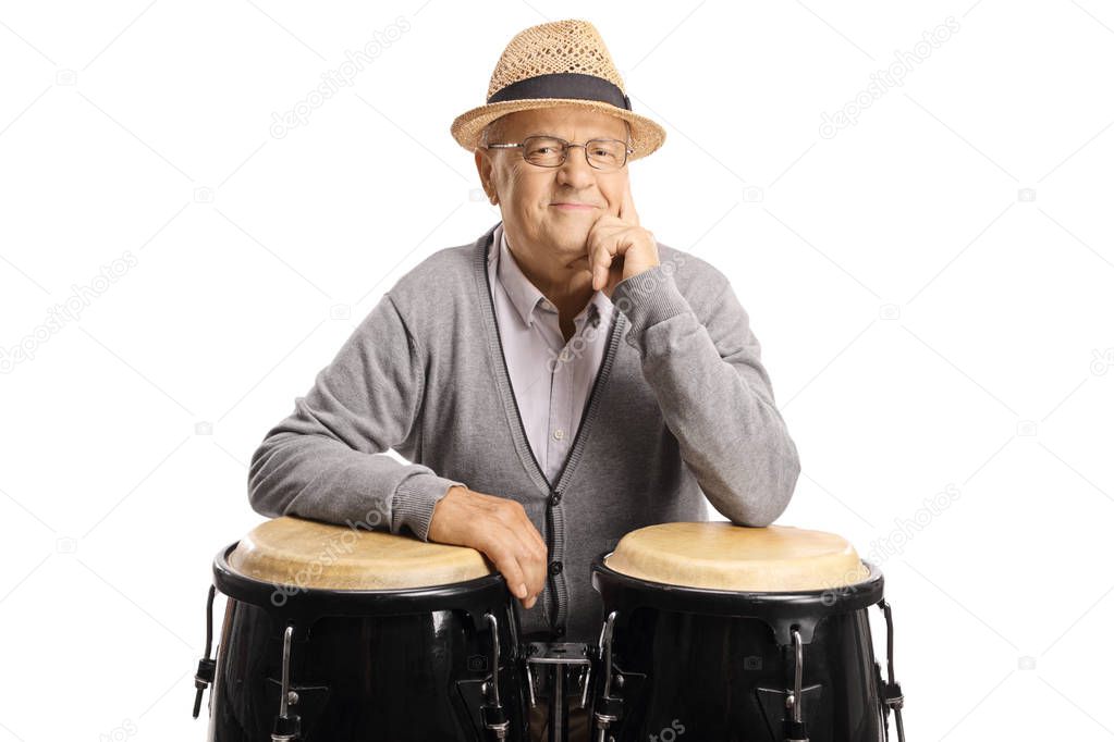 Senior man posing with conga drums
