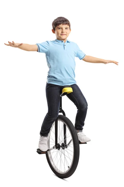 Niño macho montando un monociclo y equilibrando con las manos —  Fotos de Stock