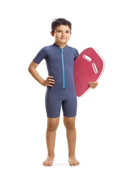Chłopiec w kombinezon posiadający pływakową planszową — Zdjęcie stockowe