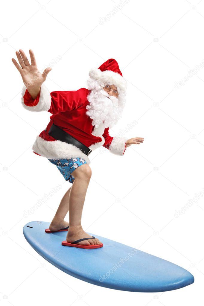 Full length shot of santa claus on a holiday surfing isolated on white background