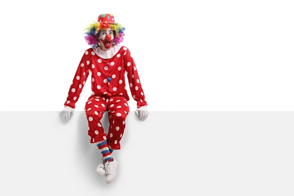 Full Längd Skott Förvånad Clown Sitter Vit Skylt Isolerad Vit — Stockfoto