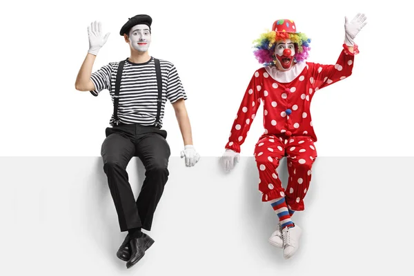 Full Length Shot Clown Mime Sitting Panel Waving Isolated White — Stock Photo, Image