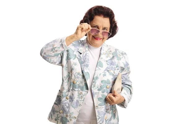 Старшая женщина в солнечных очках улыбается в камеру — стоковое фото