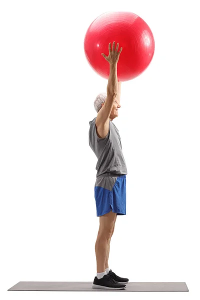 Senior man exercising pilates with a ball — Stock Photo, Image