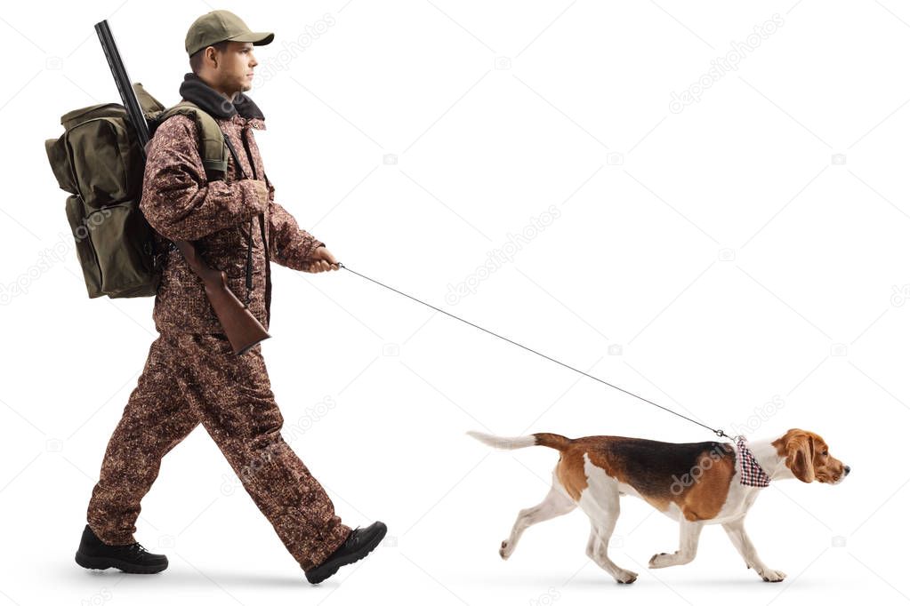 Professional hunter walking with a beagle dog