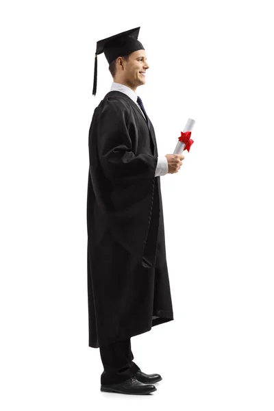Erkek mezunu ayakta ve bir diploma tutan — Stok fotoğraf