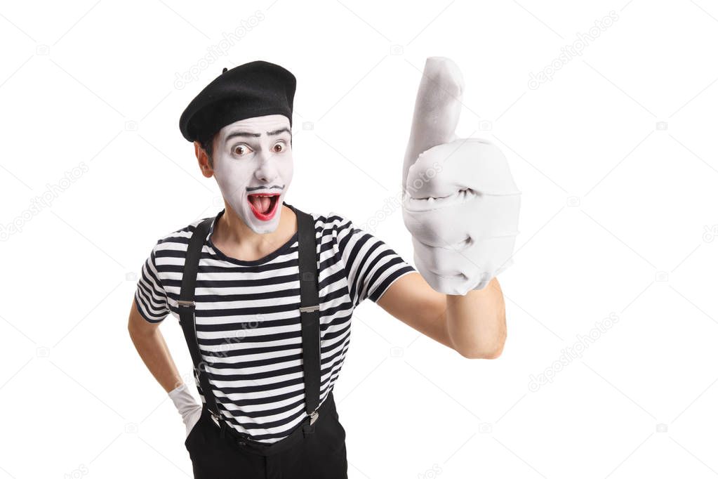 Cheerful young pantomime man showing thumbs up