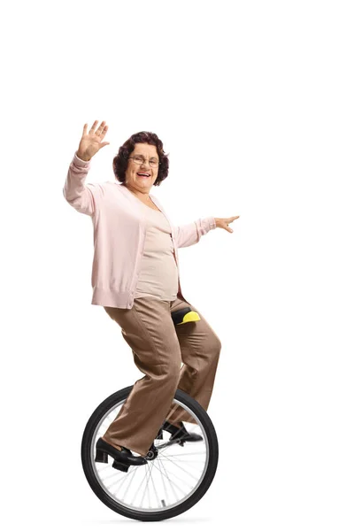 Super grandma riding a unicycle and waving — Stock Photo, Image