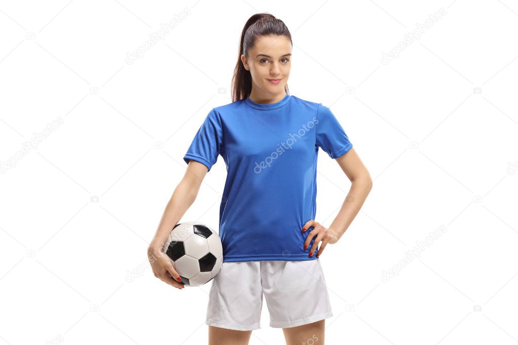 Female soccer player posing with a football