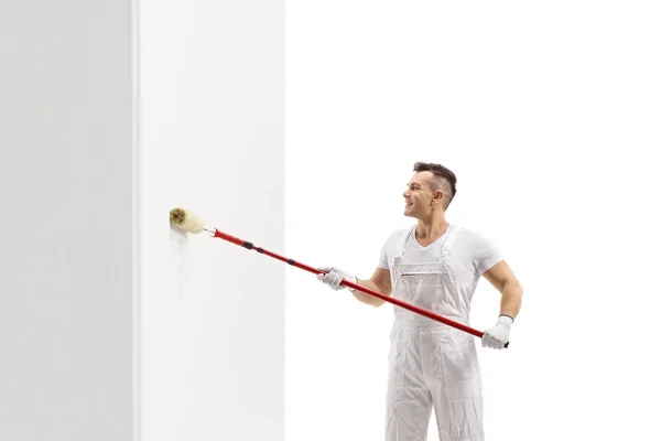 Pintor pintando una pared con un rodillo — Foto de Stock