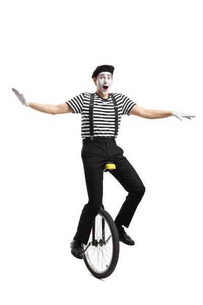 Mime riding a unicycle and balancing with hands — Stock Photo, Image