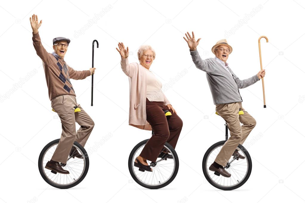Senior people riding unicycles and smiling at the camera