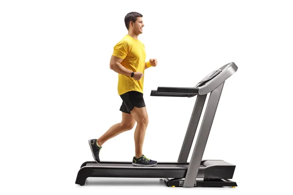 Young man running on a professional treadmill — Stock Photo, Image