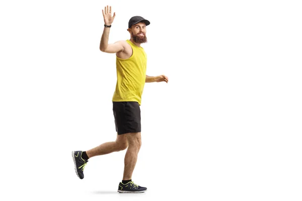 Bearded man jogging and waving — Stock Photo, Image