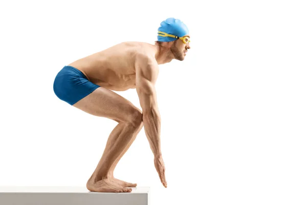 Male swimmer with cap and goggles on the start line ready to jum — Stock Photo, Image