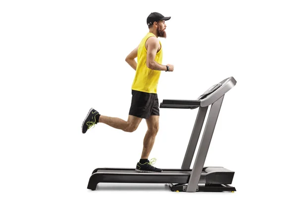 Bearded man running on a treadmill — Stock Photo, Image