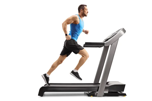 Young man in sportswear running on a professional treadmill — Stock Photo, Image