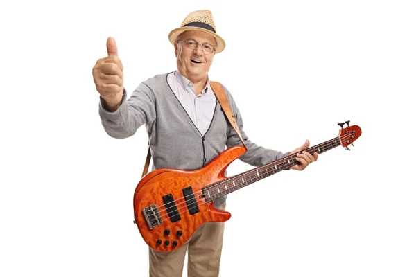 Dojrzały mężczyzna z gitarą basową pokazując kciuka w górę — Zdjęcie stockowe
